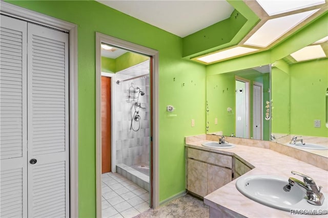 bathroom featuring vanity, a tile shower, and tile patterned floors