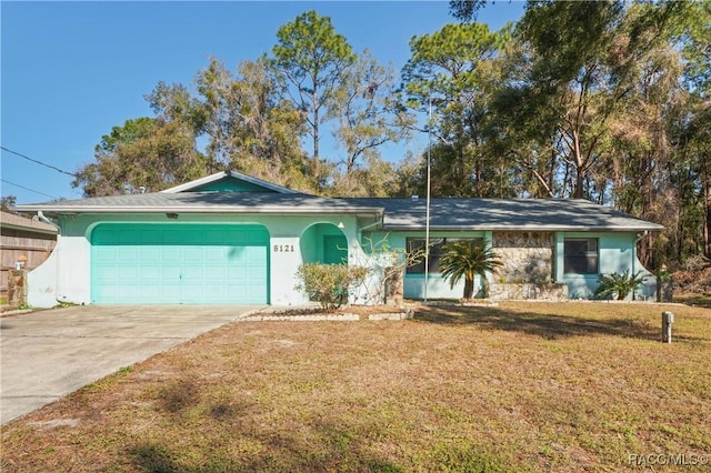 ranch-style house with a garage and a front lawn