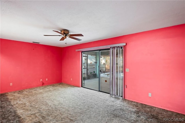 unfurnished room with ceiling fan and carpet flooring