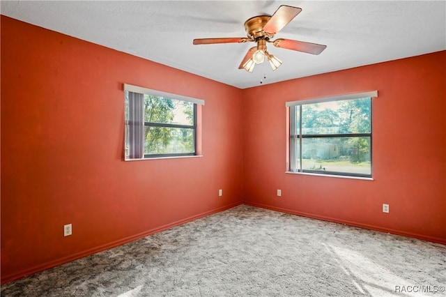 carpeted empty room featuring ceiling fan