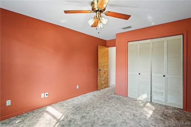 unfurnished bedroom featuring carpet floors, a closet, and ceiling fan