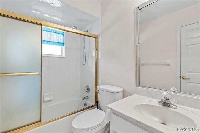 full bathroom featuring shower / bath combination with glass door, vanity, and toilet