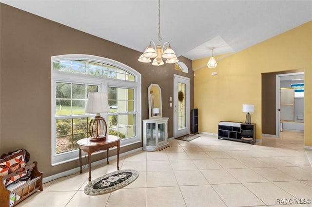 living area featuring baseboards, a chandelier, vaulted ceiling, and light tile patterned flooring