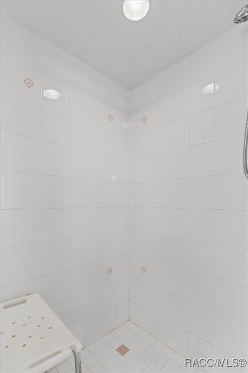 full bath featuring a tile shower