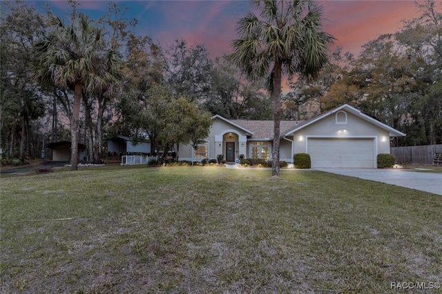 single story home with an attached garage, driveway, fence, and a front lawn