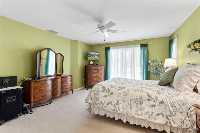 carpeted bedroom featuring ceiling fan and baseboards