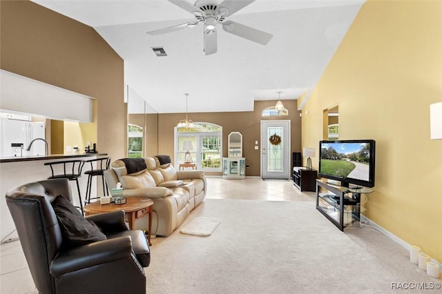 living room featuring light carpet, baseboards, visible vents, high vaulted ceiling, and light tile patterned flooring