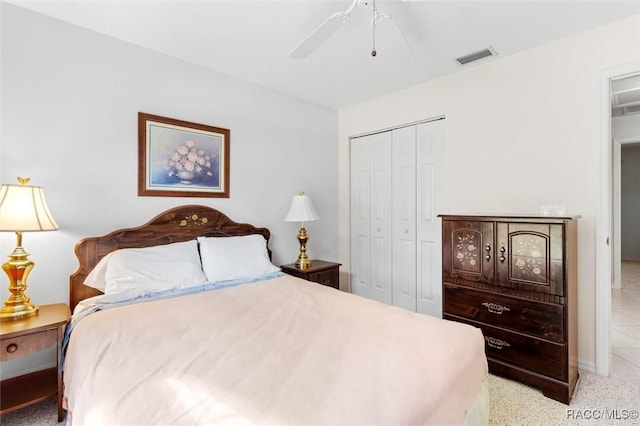 bedroom featuring ceiling fan, a closet, and visible vents