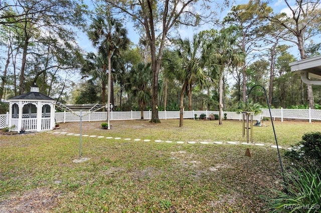 view of yard featuring fence and a gazebo