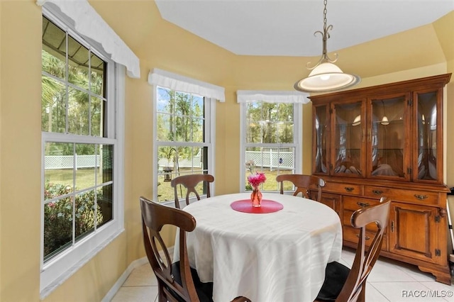 dining room with light tile patterned floors and baseboards