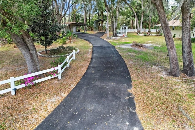 view of street featuring aphalt driveway