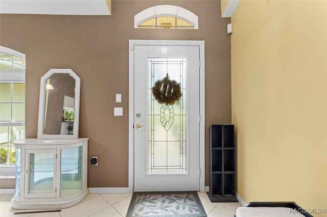 foyer with baseboards and tile patterned floors