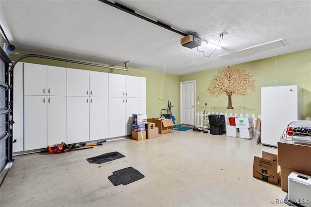 garage with freestanding refrigerator and a garage door opener