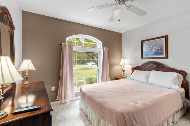 bedroom with baseboards, a ceiling fan, and light colored carpet