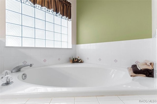 full bathroom with plenty of natural light and a bath