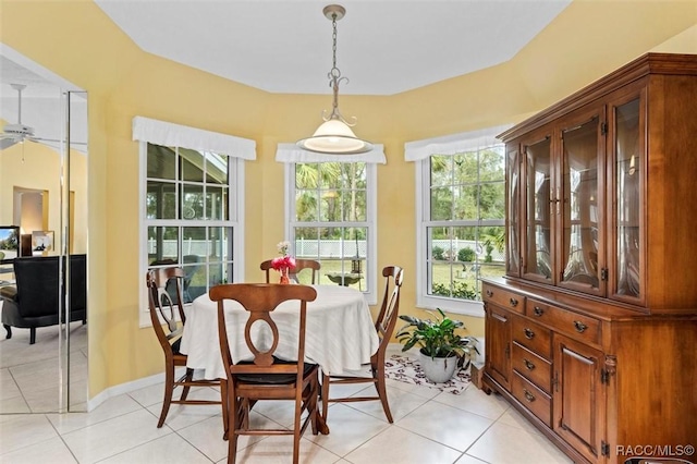 dining space with light tile patterned floors and baseboards