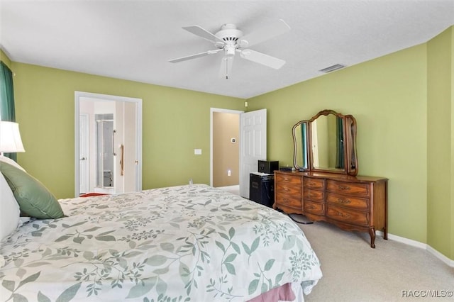 carpeted bedroom featuring a ceiling fan, visible vents, and baseboards