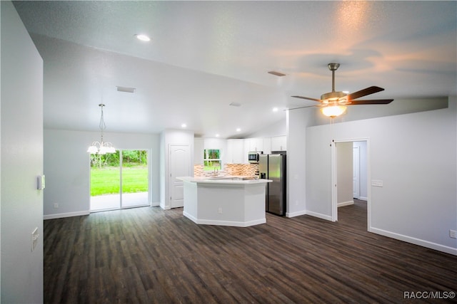 kitchen with tasteful backsplash, stainless steel appliances, dark wood-type flooring, white cabinetry, and lofted ceiling