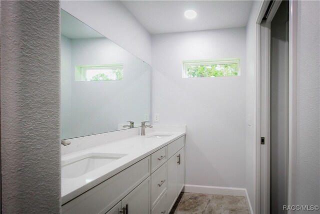 bathroom with tile patterned floors and vanity