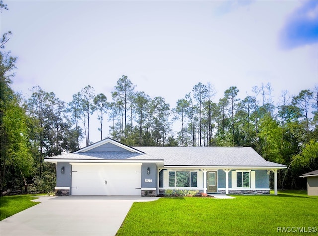 single story home featuring a garage and a front yard