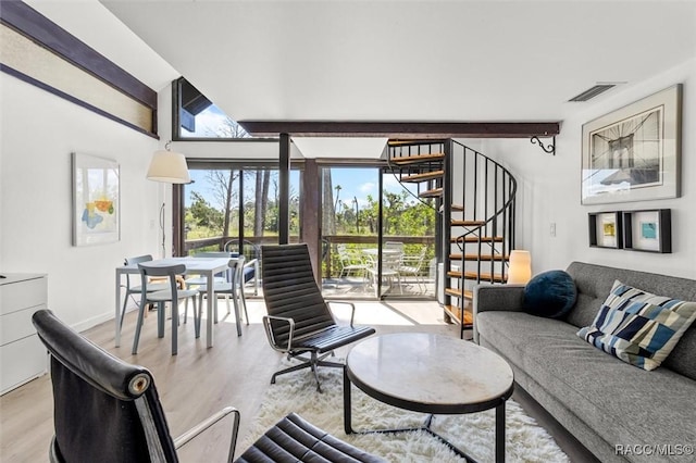 2647 N Seabreeze Pt, Crystal River, FL 34429 - living room featuring baseboards, vaulted ceiling with beams, wood finished floors, visible vents, and stairway