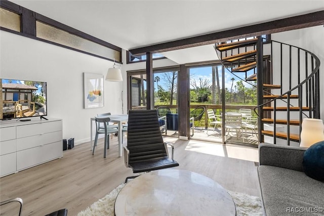 2647 N Seabreeze Pt, Crystal River, FL 34429 - living room with stairs, wood finished floors, beam ceiling, baseboards, and floor to ceiling windows