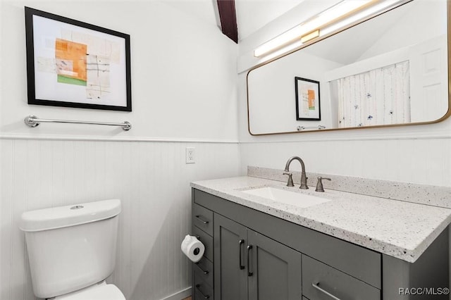 2647 N Seabreeze Pt, Crystal River, FL 34429 - bathroom with a wainscoted wall, vanity, and toilet