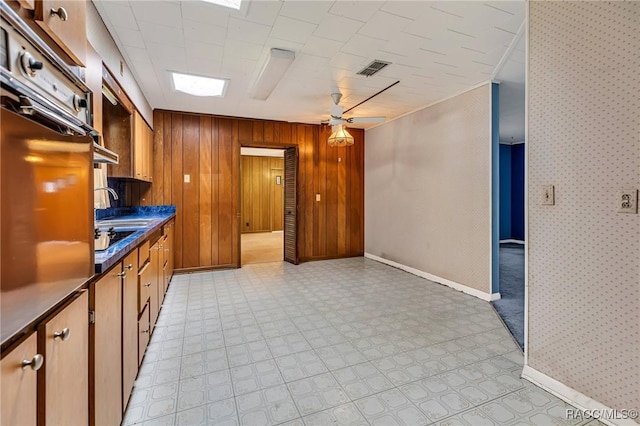 kitchen featuring sink, oven, and ceiling fan