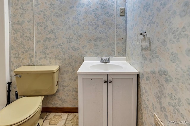 bathroom featuring vanity, tile patterned floors, and toilet