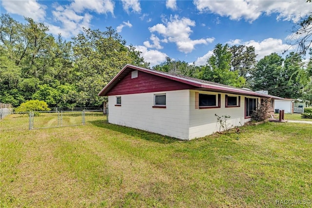 view of property exterior featuring a lawn