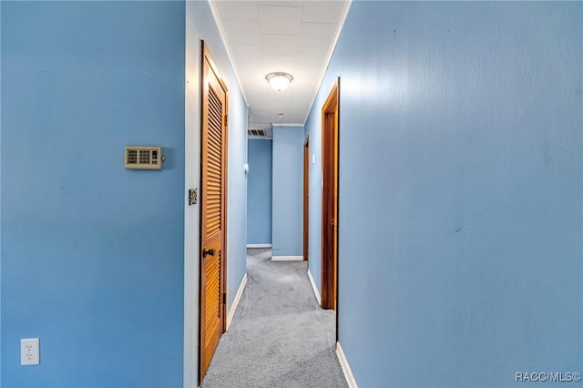 hallway with light colored carpet