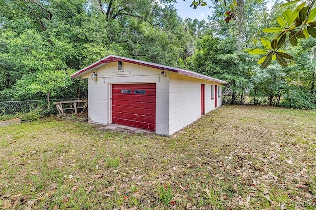 garage featuring a lawn