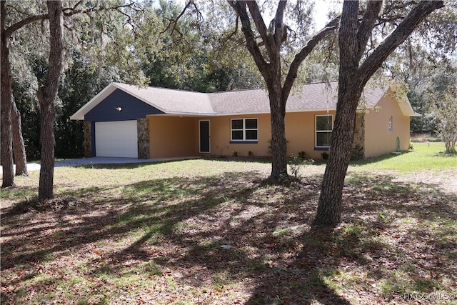 ranch-style house featuring a front yard and a garage