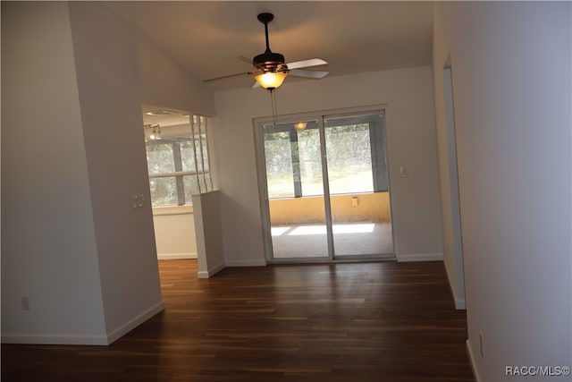 interior space with lofted ceiling, ceiling fan, and dark wood-type flooring