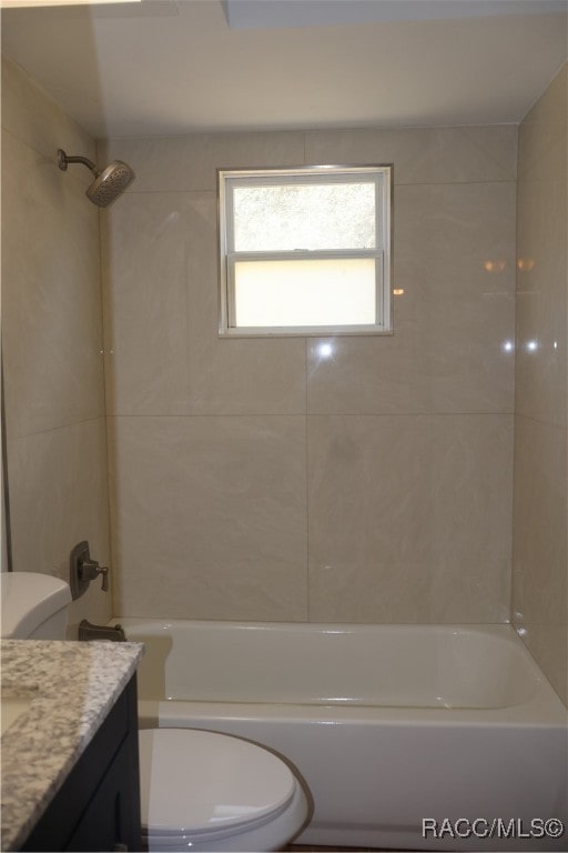 full bathroom featuring vanity, toilet, and tiled shower / bath