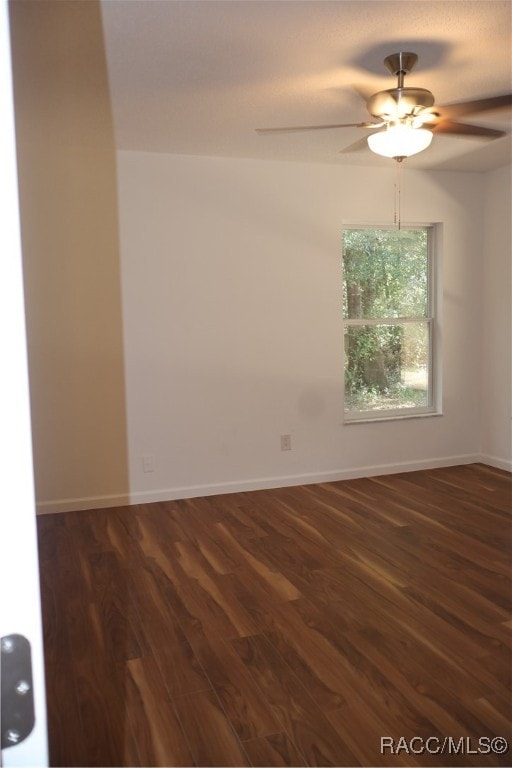 spare room featuring ceiling fan and dark hardwood / wood-style flooring