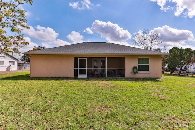 back of property featuring a yard