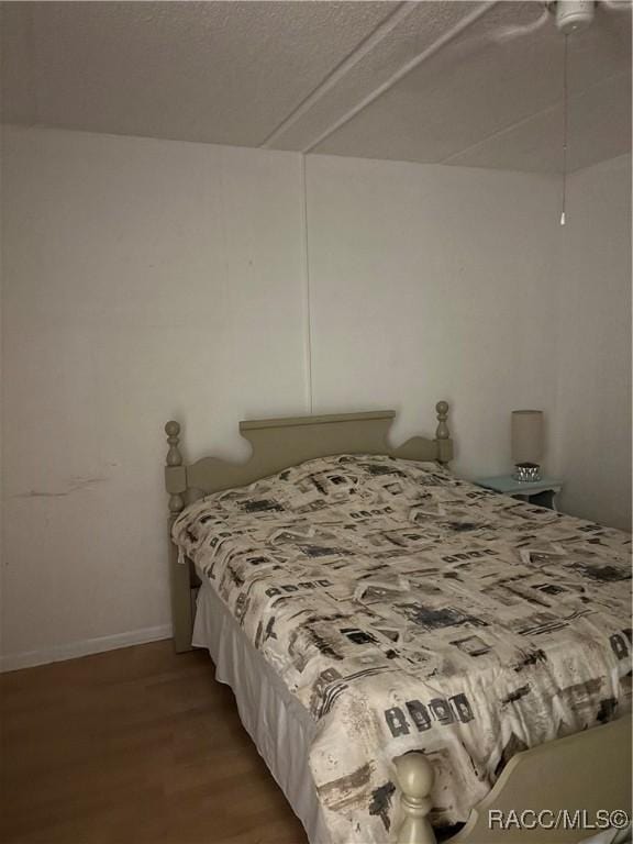 bedroom with wood-type flooring