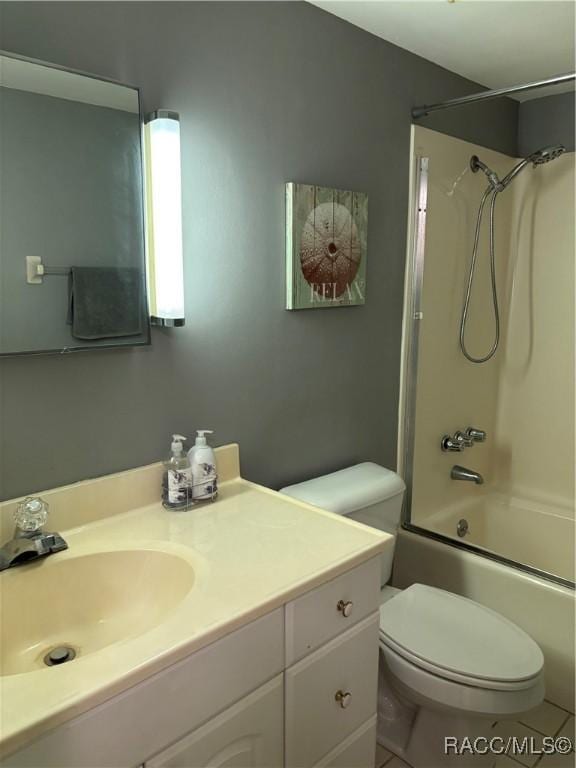 full bathroom with shower / tub combination, toilet, tile patterned floors, and vanity