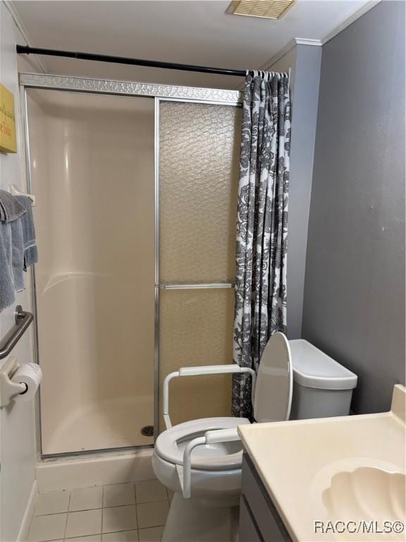 bathroom featuring walk in shower, vanity, tile patterned flooring, and toilet