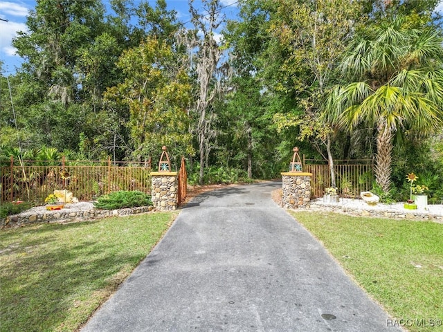 view of gate with a yard