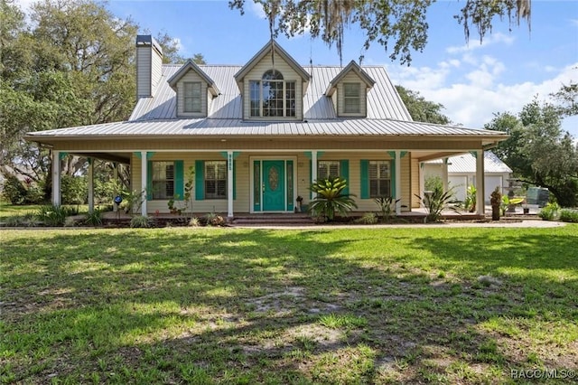 9885 E Lindale Ct, Inverness, FL 34450 - view of front of house with a porch, a chimney, a front yard, and metal roof