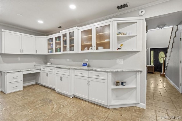9885 E Lindale Ct, Inverness, FL 34450 - kitchen featuring stone tile floors, open shelves, crown molding, white cabinetry, and recessed lighting