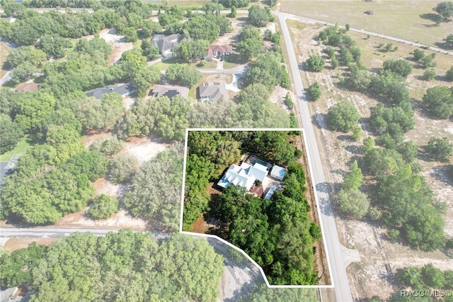 9885 E Lindale Ct, Inverness, FL 34450 - aerial view of property and surrounding area with property parcel outlined and a tree filled landscape