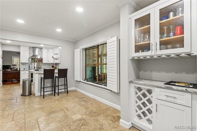 9885 E Lindale Ct, Inverness, FL 34450 - bar area with ornamental molding, wall chimney range hood, stove, stone tile floors, and baseboards
