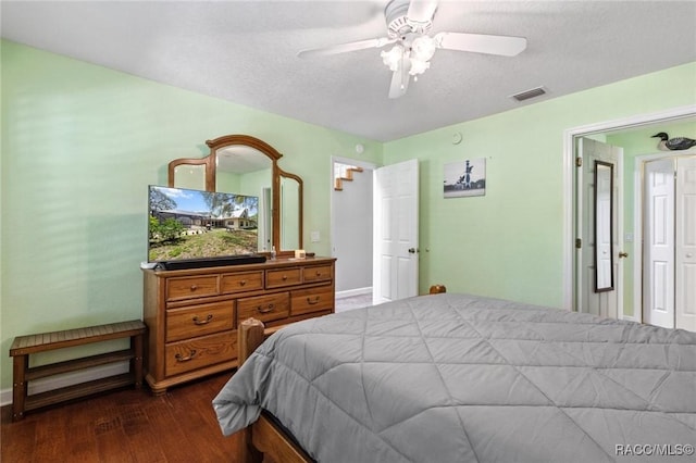 9885 E Lindale Ct, Inverness, FL 34450 - bedroom with dark wood finished floors, baseboards, ceiling fan, and a textured ceiling
