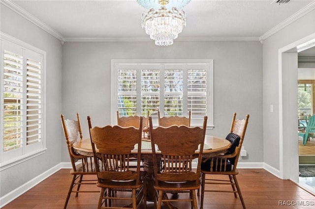 9885 E Lindale Ct, Inverness, FL 34450 - dining area featuring dark wood finished floors, crown molding, a chandelier, and baseboards