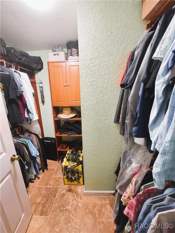 9885 E Lindale Ct, Inverness, FL 34450 - walk in closet with stone finish floors