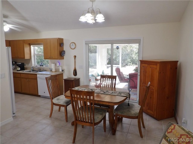 dining space featuring sink and a notable chandelier