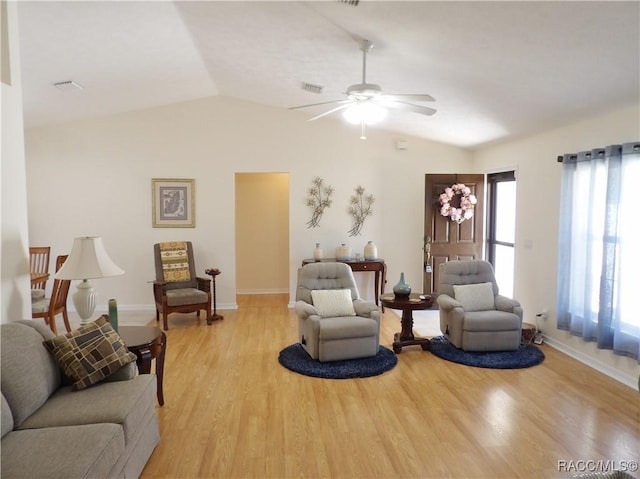 living room with lofted ceiling, ceiling fan, and light hardwood / wood-style flooring